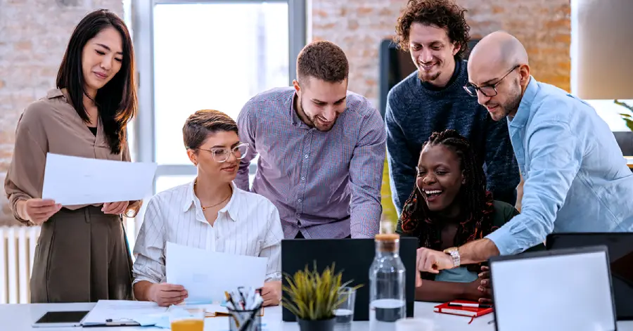 A multiracial group of corporate employees discussing about developing learning platforms for corporate training.