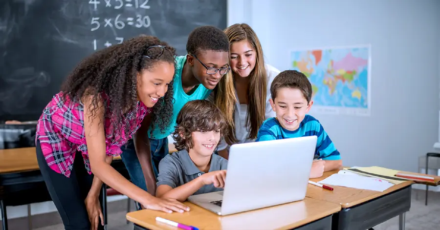 A multi-ethnic group of students learning with a laptop about the future of cloud computing in education.