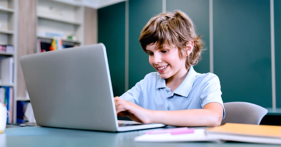 A male student with a laptop learning about multilingual captions and dubbing. 