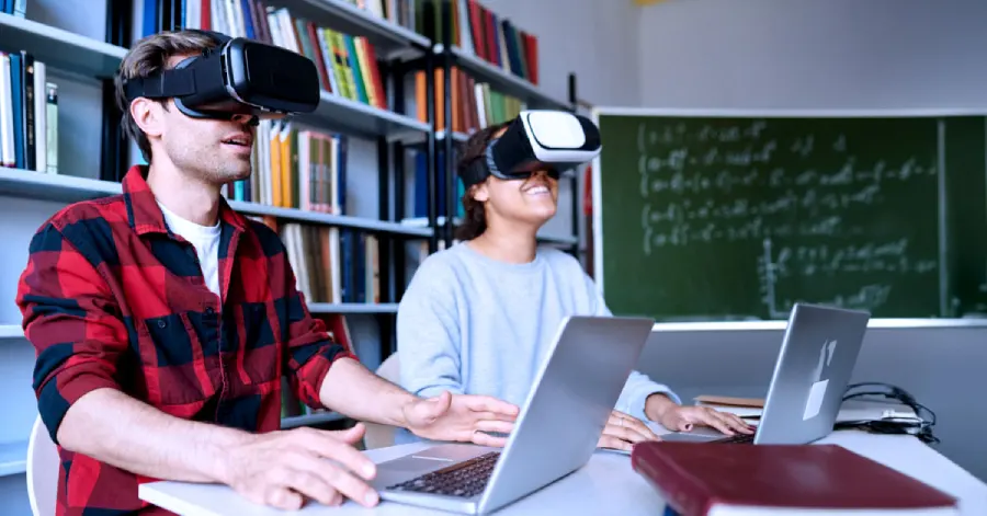 Two college students wearing VR headsets and learning about the challenges in implementing immersive learning in higher education.