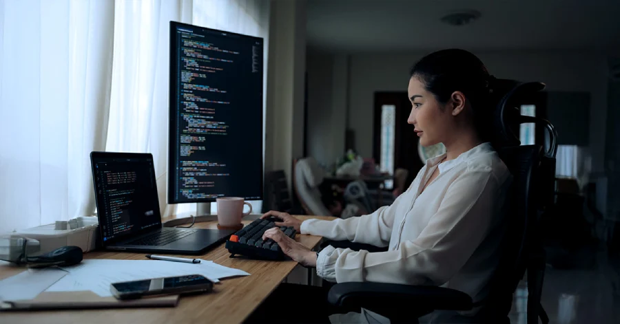  A female developer working on a desktop. 